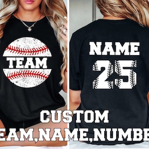 May include: Black t-shirt with a white baseball graphic and the text "TEAM" on the front. The back of the shirt has the text "NAME" and the number "25" in white.