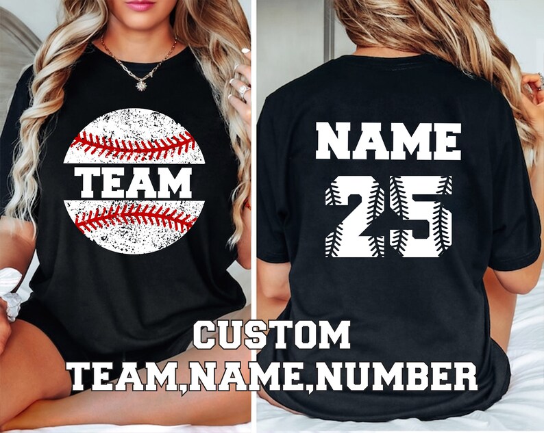May include: Black t-shirt with a white baseball graphic and the word "TEAM" on the front. The back of the shirt has a white baseball graphic with the text "NAME" and the number "25".