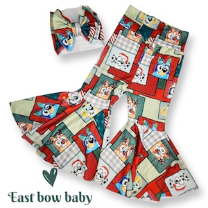 May include: A red, green, and blue patterned bell bottom pants and headband set featuring a cartoon dog character. The headband is a bow. The pants have a patchwork design with a variety of holiday-themed patterns.