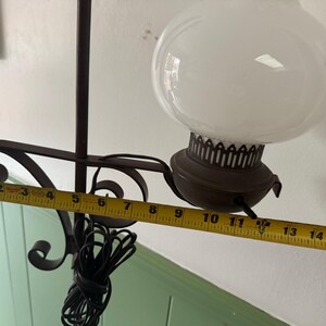 May include: A vintage hanging lamp with a white globe shade and a dark brown metal frame. The lamp's total length is approximately 16 inches. The lamp has a decorative metal base and a black electrical cord.