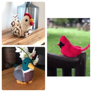 May include: A collection of handmade crochet bird figurines, including a hen with a red comb, a red cardinal, and a duck with a teal head and yellow beak. The hen has a cream and brown patterned body.