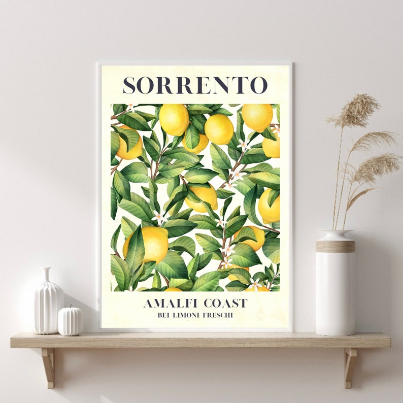 May include: A white poster with the text "SORRENTO AMALFI COAST  BEI LIMONI FRESCHI" in blue and black lettering. The poster features a watercolor illustration of a lemon tree with yellow lemons and green leaves.