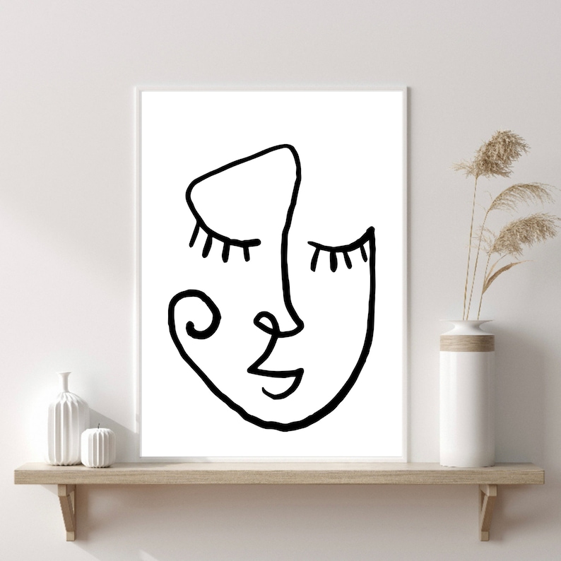 Pu&ograve; includere: Stampa di arte di linea in bianco e nero di un viso stilizzato con gli occhi chiusi. Il viso &egrave; disegnato in uno stile semplice e astratto.