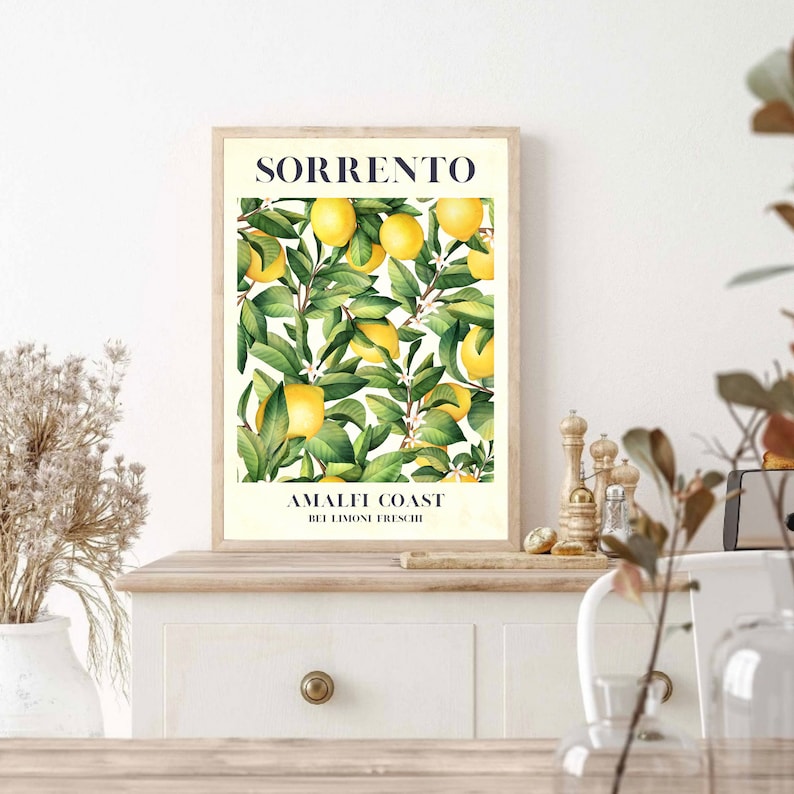 May include: A vintage-style poster with a watercolor illustration of a lemon tree with yellow lemons and green leaves. The poster has the text "SORRENTO" in blue at the top and "AMALFI COAST  BEI LIMONI FRESCHI" in black at the bottom.