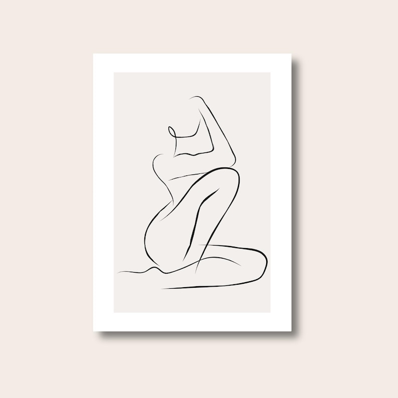 May include: A minimalist line art print featuring a seated figure in a graceful pose. The artwork is rendered in black lines against a neutral background, creating a modern and elegant aesthetic. The print is framed in a white border.