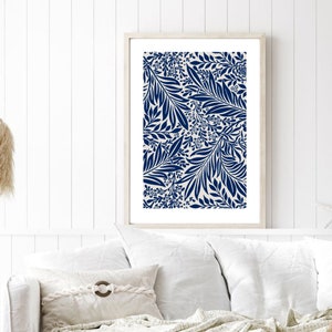 May include: A framed print with a navy blue and white floral pattern. The pattern features stylized leaves and flowers.