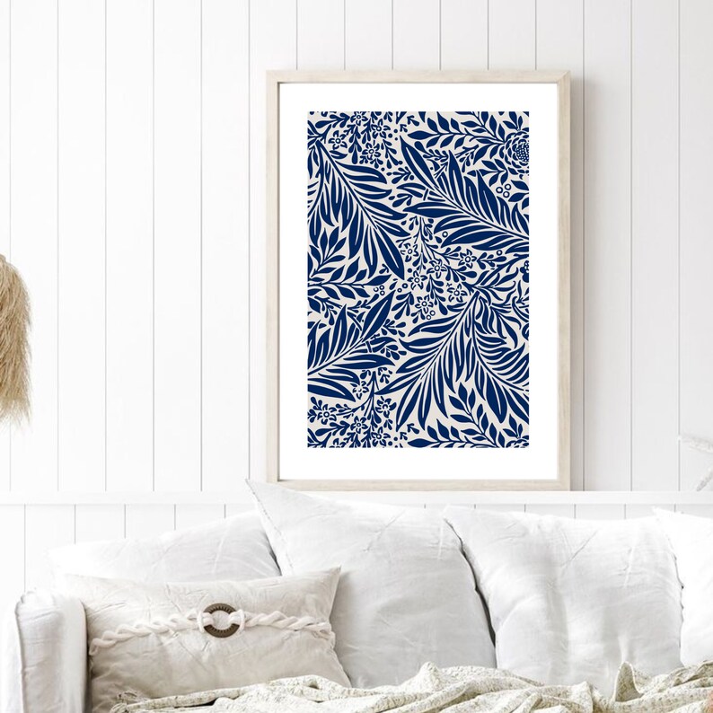 May include: A framed print with a navy blue and white floral pattern. The pattern features stylized leaves and flowers.