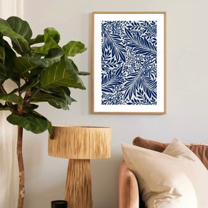 May include: A framed print with a blue and white floral pattern. The pattern features stylized leaves and flowers in a repeating design.