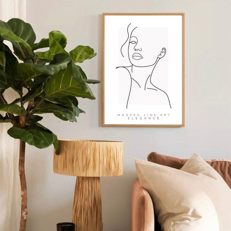 May include: A black and white line art print of a woman's face with the text "MODERN LINE ART ELEGANCE" below the image.