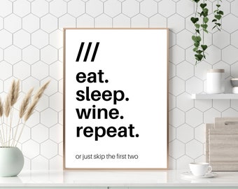 May include: A white framed print with black text that reads "/// eat. sleep. wine. repeat. or just skip the first two". The print is hanging on a white tiled wall.