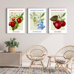May include: Three vintage-style prints featuring illustrations of strawberries, blueberries, and cherries. Each print has a light green background with the French words "March&eacute; aux Fruits" and the name of the fruit in French at the bottom.
