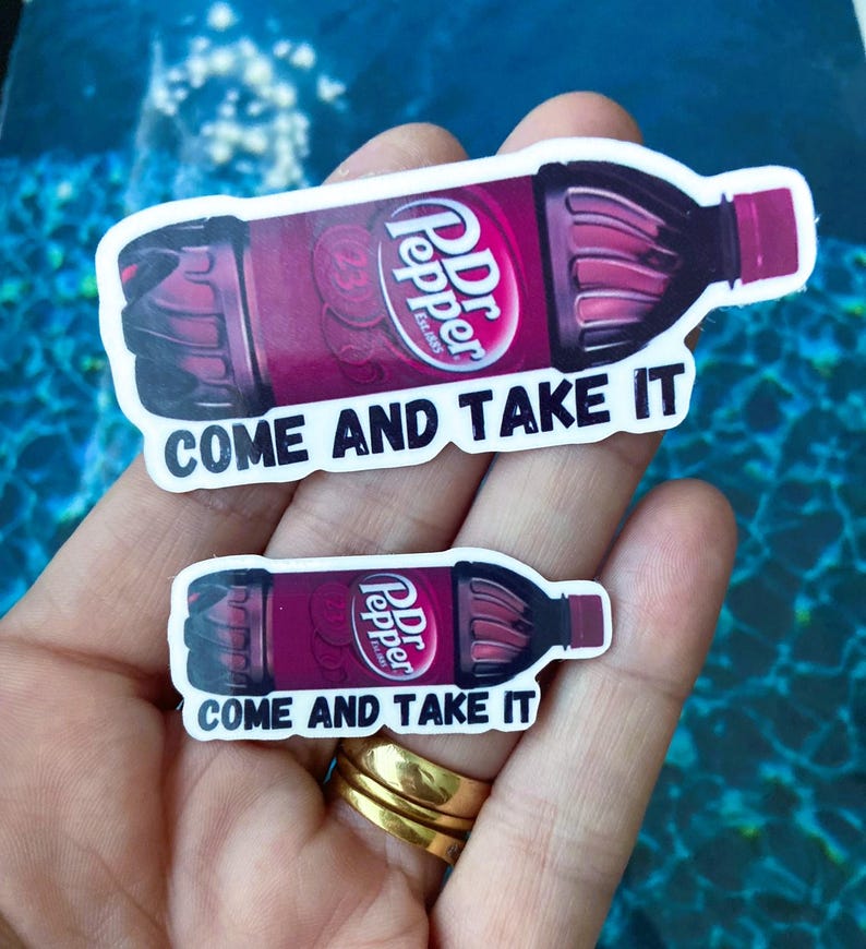 May include: Two stickers featuring a Dr Pepper bottle with the text "Come and Take It". The stickers are on a hand with a ring.