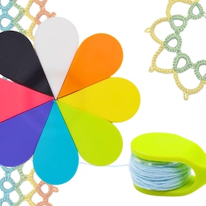 Può includere: Un set di porta-filati in plastica a forma di fiore di diversi colori con un porta-filati verde e un'bobina di filo blu.