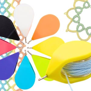May include: A set of colorful crochet hooks with a yellow thread holder. The hooks are shaped like teardrops and have a metal hook at the end. The thread holder has a clear plastic spool and a blue thread.