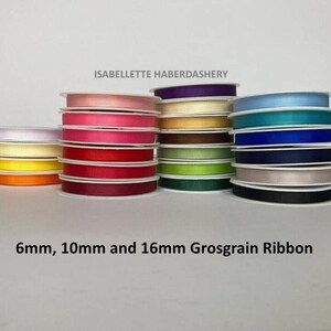 May include: Spools of grosgrain ribbon in various colors, including orange, yellow, pink, red, green, blue, and black. The ribbon is available in 6mm, 10mm, and 16mm widths. The text "ISABELLETTE HABERDASHERY" is at the top.