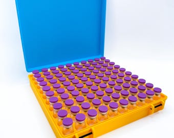 May include: A yellow storage case with a bright blue lid containing a grid of eighty-one small, clear glass vials. Each vial is topped with a purple cap and arranged in a nine-by-nine square formation within the rectangular container.