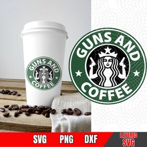 May include: A white coffee cup with a green and black logo that says "Guns and Coffee" with a mermaid holding two guns. The logo is surrounded by stars.