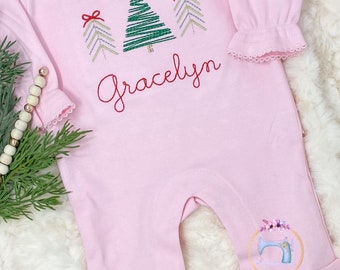 May include: Pink long-sleeved baby onesie with a ruffled hem and embroidered Christmas trees and the name "Gracelyn".