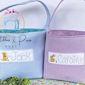 May include: Two personalized Easter baskets, one blue with a dog and the name "Jack" and one purple with a bunny and the name "Caroline".