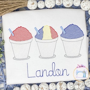 May include: Embroidered design of three snow cones in red, yellow, and blue with a white cup and straw. The name Landon is embroidered below the snow cones.