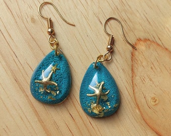 Ocean resin earrings, w/ gold flake accent - gold starfish and blue alcohol ink background