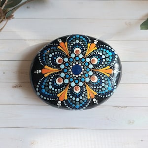 Blue, orange and white mandala stone, meditation sacred geometry, real painted rock