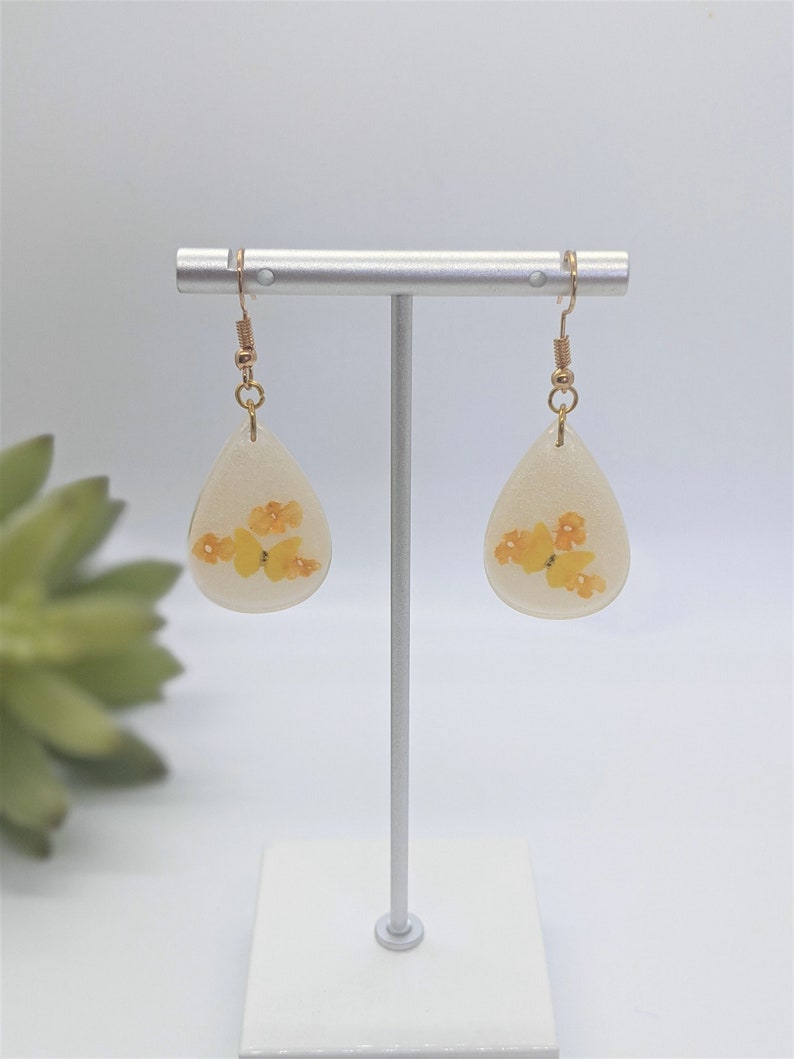 Yellow butterfly and real dried orange lantana flower teardrop resin earrings with gold plated French hooks
