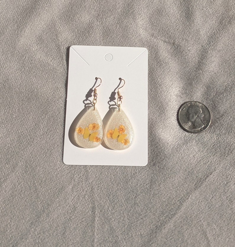 Yellow butterfly and real dried orange lantana flower teardrop resin earrings with gold plated French hooks