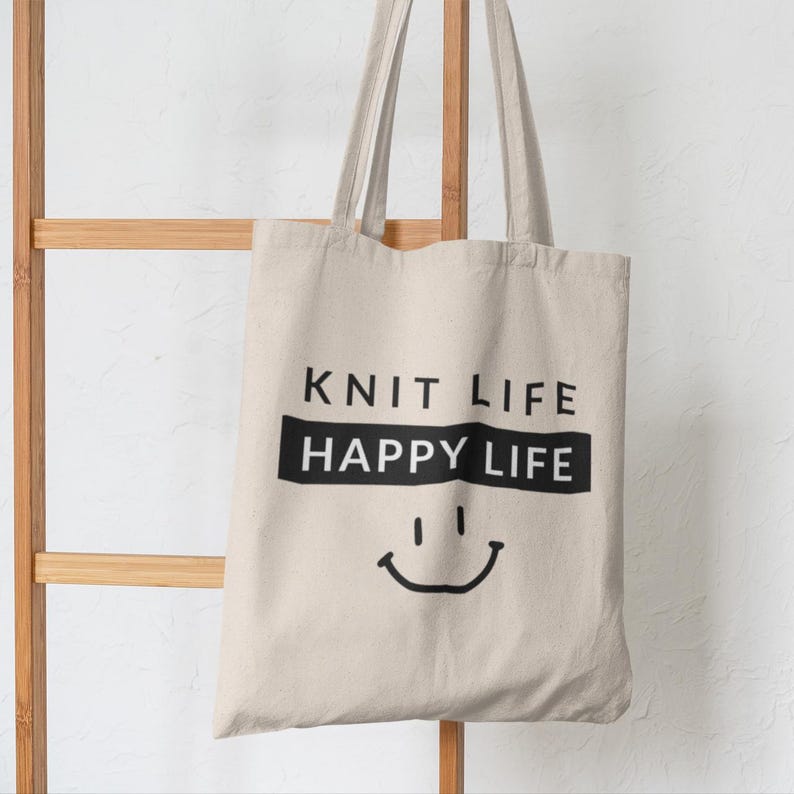 Tote bag hanging on decor.  Bag says "Knit Life Happy Life"