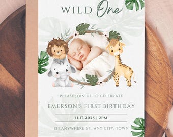 May include: A Wild One birthday invitation featuring a sleeping baby surrounded by cartoon animals. The invitation includes the text "PLEASE JOIN US TO CELEBRATE EMERSON'S FIRST BIRTHDAY" and the date, time, and address.