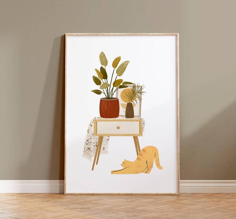 May include: A framed art print featuring a stylized illustration of a potted plant, a small vase, and a decorative picture on a small table. A stretching orange cat is in the foreground. The artwork has a neutral color palette with a modern, minimalist aesthetic.