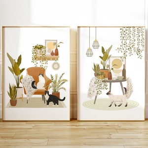May include: Two framed art prints featuring interior scenes with cats and plants. One print shows a cat on a chair, surrounded by potted plants. The other print depicts a cat near a table with plants and hanging lamps. Both prints have a gold frame.