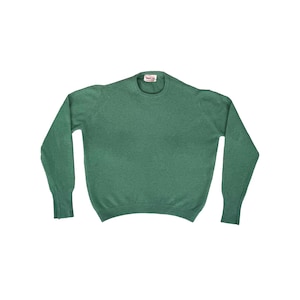 May include: A solid green crew neck sweater with long sleeves. The sweater has a ribbed cuff and a small tag at the neckline. The fabric appears to be a soft knit material. The sweater is displayed on a white background.