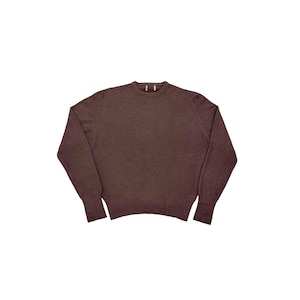May include: A brown crew neck sweater with long sleeves. The sweater is a solid color and appears to be made of a soft material. The cuffs and hem are ribbed.