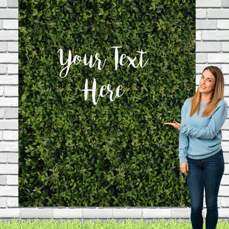 May include: Green artificial foliage backdrop with the text "Your Text Here" in white. The backdrop is being held by a person.