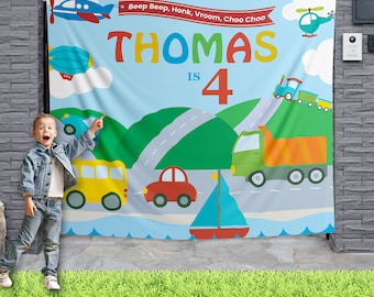 May include: A blue and white birthday banner with the text "Beep Beep, Honk, Vroom, Choo Choo" and "Thomas is 4". The banner features a variety of colorful vehicles, including a blue airplane, a red car, a yellow bus, a green truck, and a train.