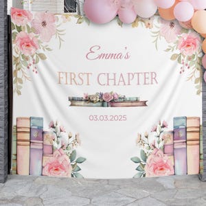 May include: A white backdrop with a pink floral design and the text "Emma's First Chapter" with the date "03.03.2025" printed below.  The backdrop features stacks of books with a watercolor effect.