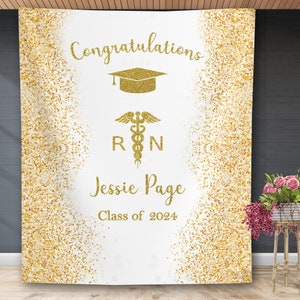 May include: Gold glitter graduation backdrop with the text "Congratulations", a graduation cap, a medical symbol with the letters "RN", the name "Jessie Page", and the text "Class of 2024".