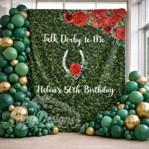 May include: A backdrop with the text "Talk Derby to Me" and "Helen's 50th Birthday" against a green hedge wall. Red roses and a horseshoe with a red rose are featured. Green and gold balloons frame the backdrop.
