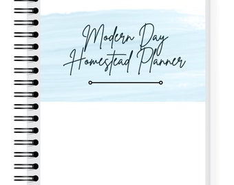 May include: A white spiral bound notebook with a light blue watercolor background and the text "Modern Day Homestead Planner" in black.