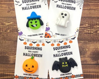 May include: Four Halloween-themed cards featuring small squishy toys: a green witch with a blue hat, a white ghost, an orange pumpkin, and a black bat. Each card displays the text SQUISHING YOU A HAPPY HALLOWEEN with various sender names.
