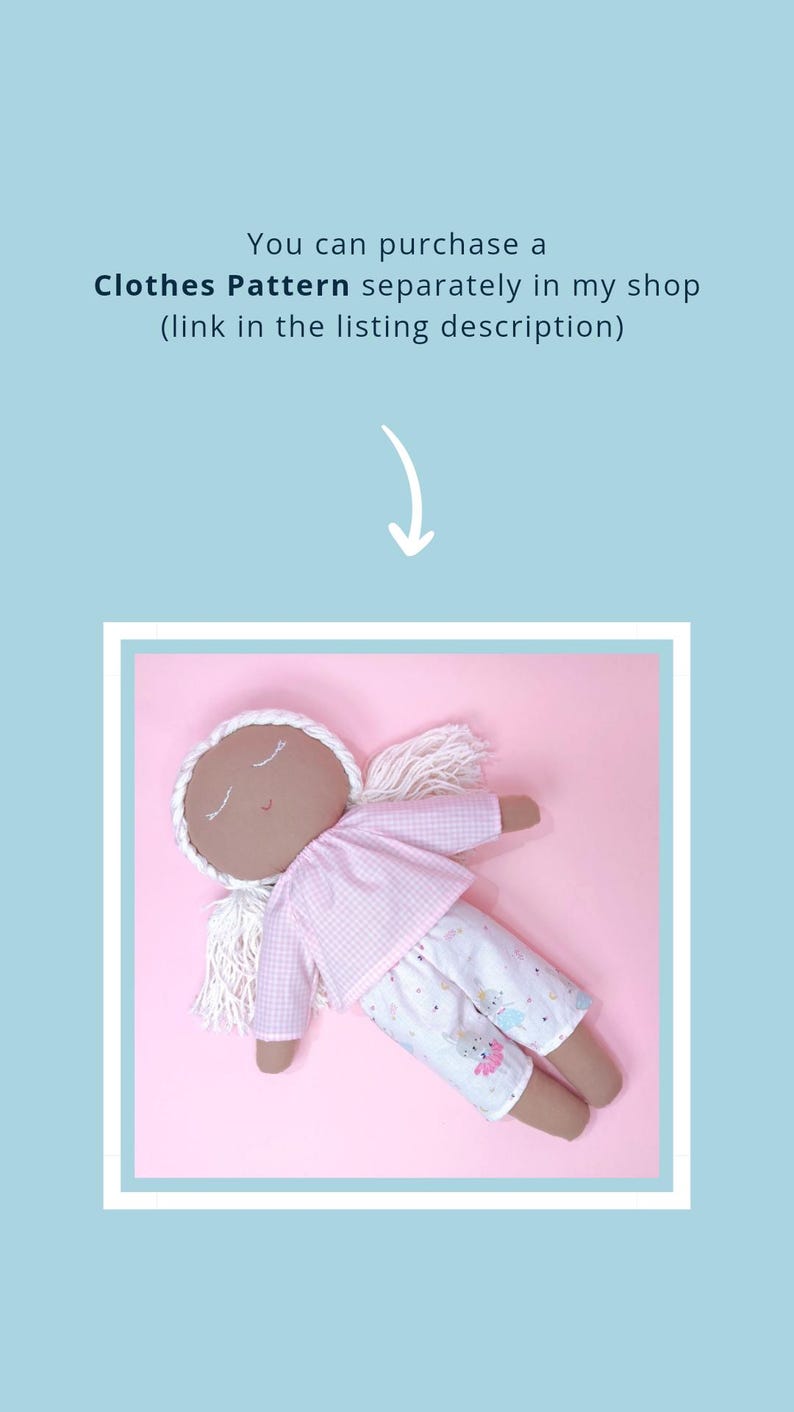 May include: A handmade doll with brown skin, closed eyes, and white yarn hair. The doll is wearing a pink and white gingham shirt and white pants with a pink and blue print. The doll is lying on a pink background.
