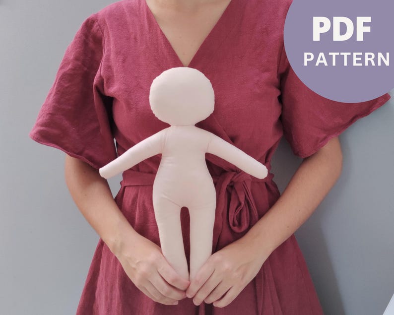May include: A PDF pattern for sewing a simple doll. The doll is made of fabric and has a light pink color. The pattern is for a doll with a simple design, with no facial features or clothing.