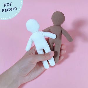 May include: Two small, blank fabric doll figures, one in white and one in brown, featuring simple rounded heads and limbs. The text "PDF Pattern" is visible in the upper left corner, indicating this is a digital template for sewing these dolls.