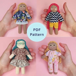 May include: Four small handmade fabric dolls with yarn hair and embroidered facial features, each wearing different patterned outfits. The dolls are displayed in a grid, with a central circular label that reads PDF Pattern in blue text.