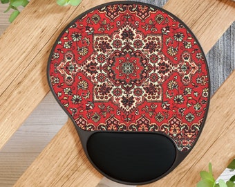 May include: A red and black mouse pad with a patterned design resembling a traditional rug. The pad has a built-in wrist rest.