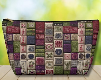 May include: A zipped pouch featuring a repeating pattern of rectangular mahjong tiles in various colours including red, green, purple, and white. The tiles are decorated with intricate floral motifs, geometric patterns, and traditional Chinese characters.