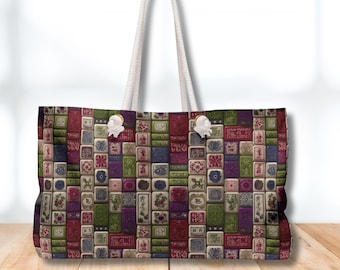 May include: A large tote bag with a colorful pattern of rectangular tiles in shades of red, green, purple, and blue. The bag has white rope handles and white decorative accents. The bag is sitting on a wooden surface.