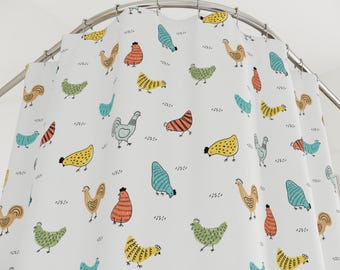 May include: White shower curtain with a repeating pattern of colorful cartoon chickens and roosters. The chickens are in various colors, including yellow, orange, green, and blue, with black detailing. The curtain hangs from a curved metal rod.