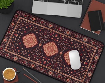 May include: A rectangular desk mat with a burgundy and beige geometric pattern resembling a traditional rug. The mat features a central design with floral and geometric motifs, and a black border. A white computer mouse rests on the mat.